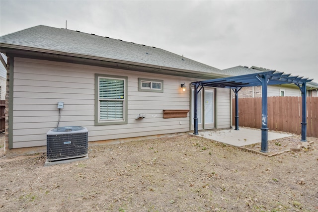 back of property featuring a pergola, cooling unit, and a patio