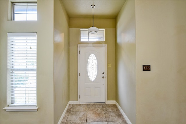 foyer featuring light tile patterned floors and a wealth of natural light