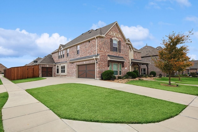 view of front of home with a garage and a front lawn