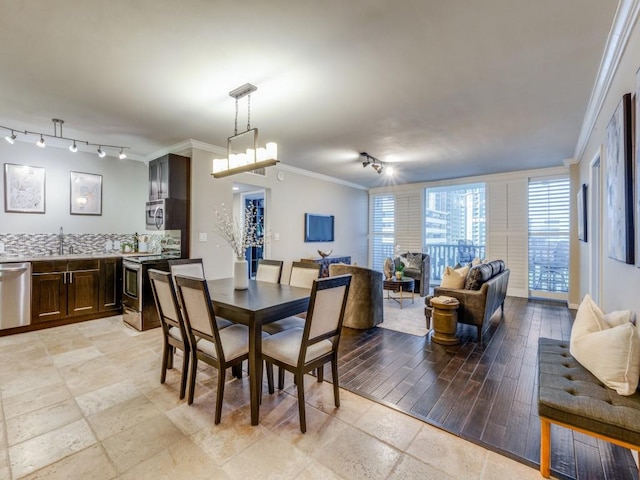 3701 Turtle Creek Blvd Unit 11H, Dallas, TX 75219 - dining room featuring ornamental molding and track lighting