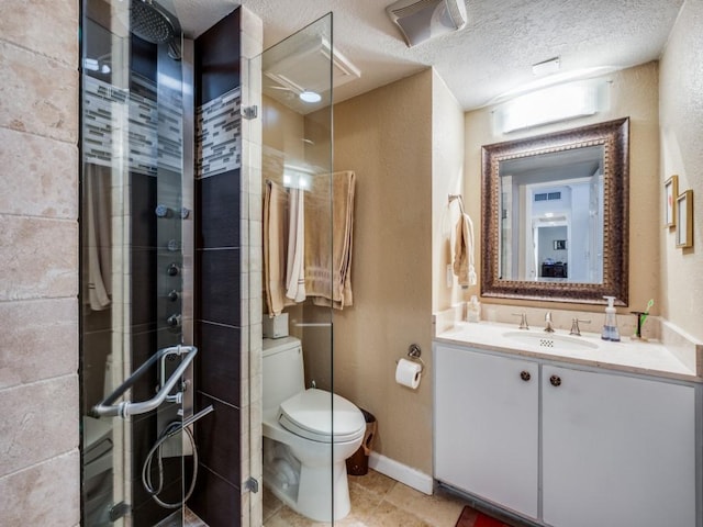 bathroom featuring tile patterned floors, toilet, a textured ceiling, a tile shower, and vanity