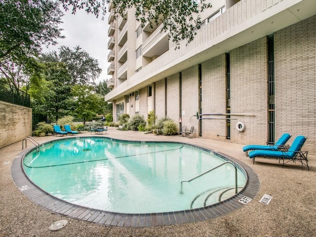 community pool with a patio area