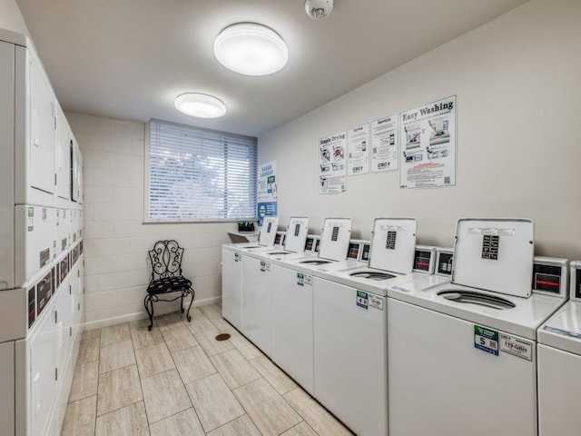 shared laundry room featuring washer and clothes dryer and stacked washer / drying machine