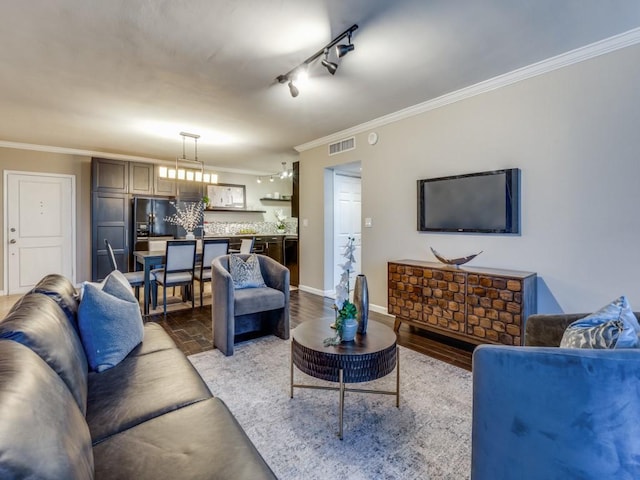 3701 Turtle Creek Blvd Unit 11H, Dallas, TX 75219 - living room featuring crown molding, rail lighting, and baseboards