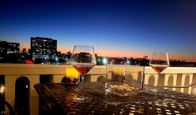 patio terrace at dusk with a view of city