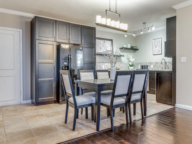 3701 Turtle Creek Blvd Unit 11H, Dallas, TX 75219 - dining space with ornamental molding, baseboards, and light wood-type flooring