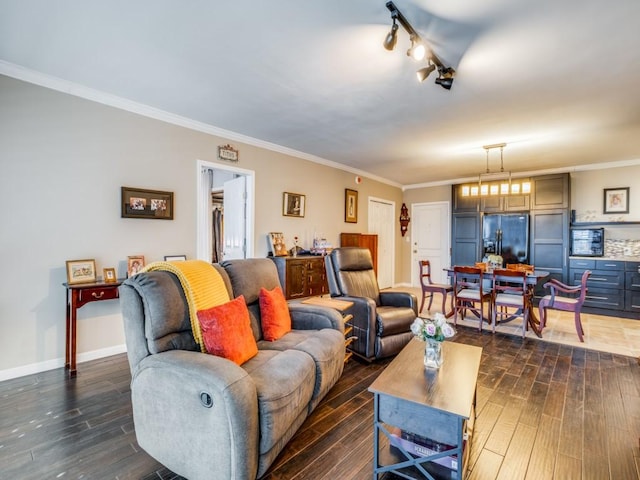 living room featuring ornamental molding, rail lighting, and dark wood-type flooring