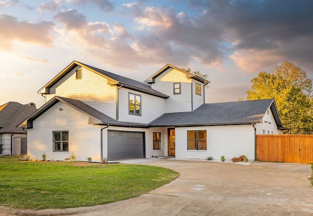 view of front of property featuring a yard and a garage