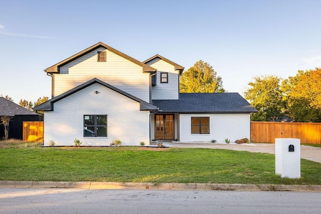 view of property featuring a front lawn