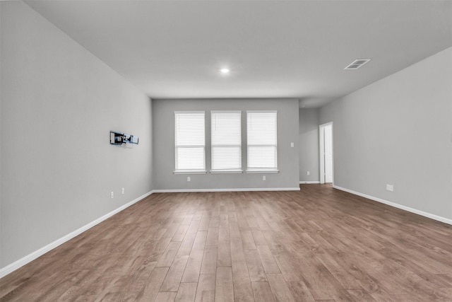 empty room with hardwood / wood-style floors