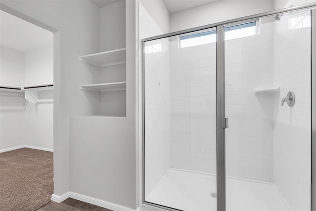 bathroom featuring a shower with door