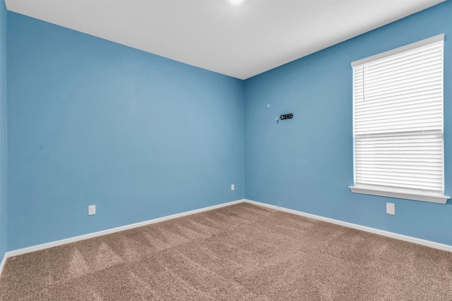 carpeted empty room with a wealth of natural light