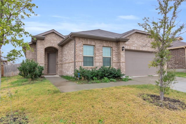 view of front of property featuring a front yard and a garage