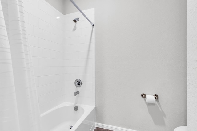 bathroom featuring shower / bath combo and toilet