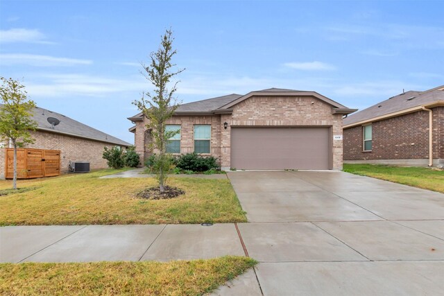 ranch-style house with central AC unit, a garage, and a front lawn