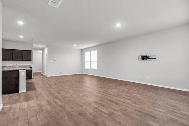 unfurnished living room with light hardwood / wood-style flooring