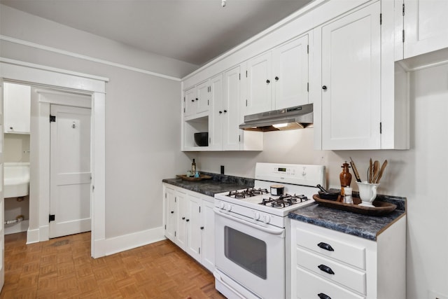 kitchen featuring white cabinets, light parquet flooring, and white gas stove