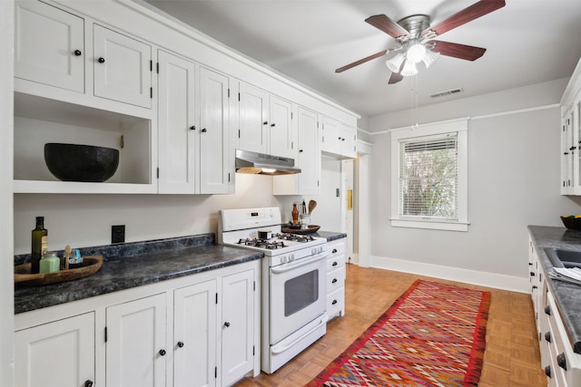 kitchen with white cabinets, light parquet flooring, ceiling fan, and gas range gas stove