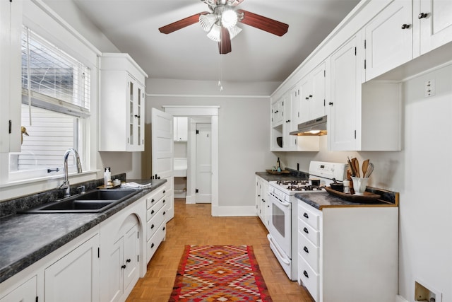 kitchen featuring light parquet floors, sink, ceiling fan, white cabinetry, and white range with gas cooktop