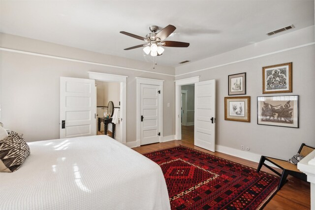 bedroom featuring hardwood / wood-style flooring and ceiling fan