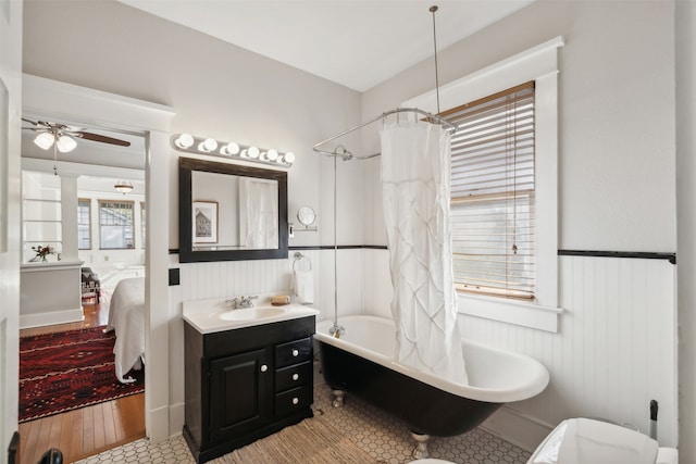 bathroom with hardwood / wood-style flooring, shower / bath combo, ceiling fan, and vanity