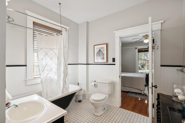 bathroom featuring wood-type flooring, vanity, toilet, and ceiling fan