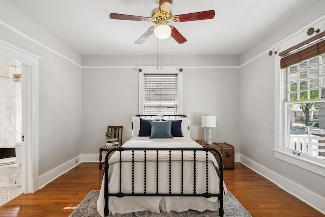 bedroom with ensuite bath, ceiling fan, and hardwood / wood-style floors