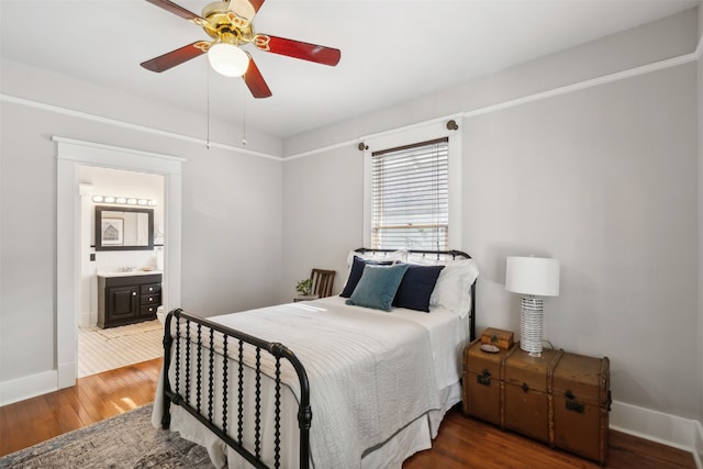 bedroom with dark hardwood / wood-style flooring, ensuite bathroom, and ceiling fan