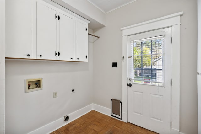 washroom with hookup for an electric dryer, washer hookup, cabinets, dark parquet floors, and crown molding