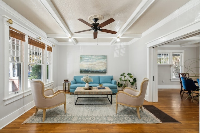 living area featuring ceiling fan, coffered ceiling, beamed ceiling, hardwood / wood-style floors, and a textured ceiling