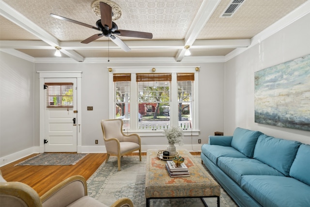 living room with hardwood / wood-style floors, a healthy amount of sunlight, beamed ceiling, and coffered ceiling