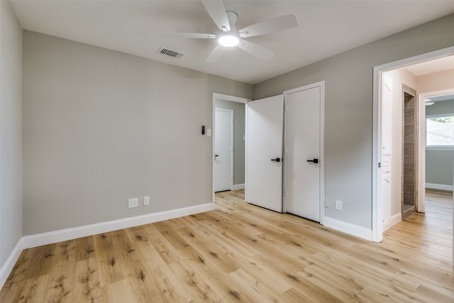 unfurnished bedroom featuring light wood-type flooring and ceiling fan