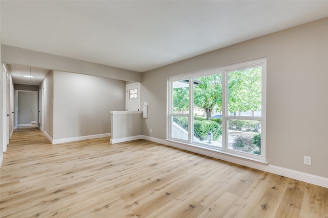 unfurnished room with light hardwood / wood-style flooring