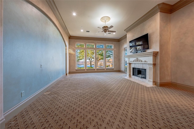 unfurnished living room featuring ceiling fan, light colored carpet, ornamental molding, and a fireplace