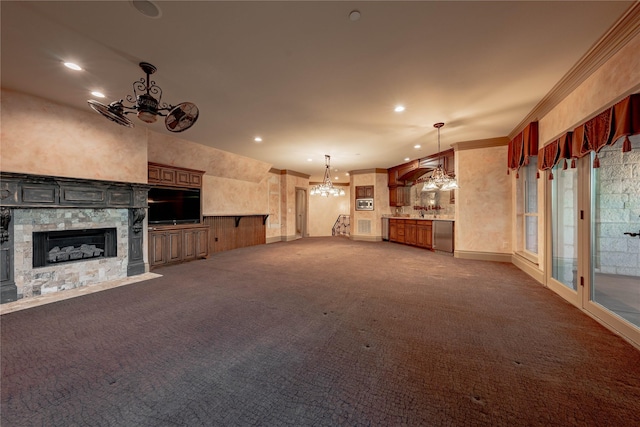 unfurnished living room featuring carpet flooring, a fireplace, and ornamental molding