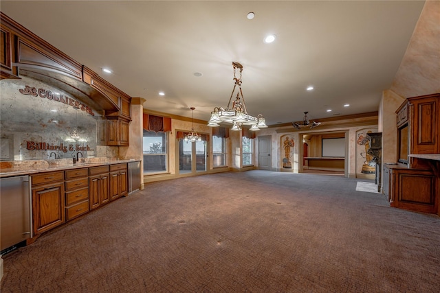 kitchen featuring light stone countertops, dark carpet, ceiling fan, decorative light fixtures, and dishwasher