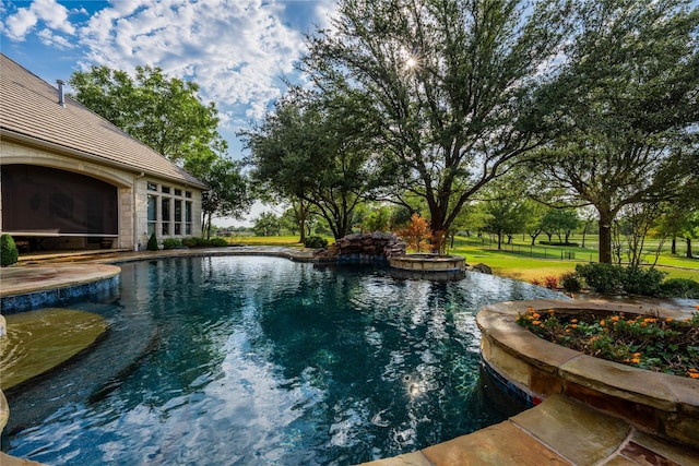 view of swimming pool with a yard