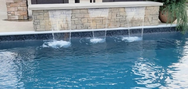 view of pool featuring pool water feature