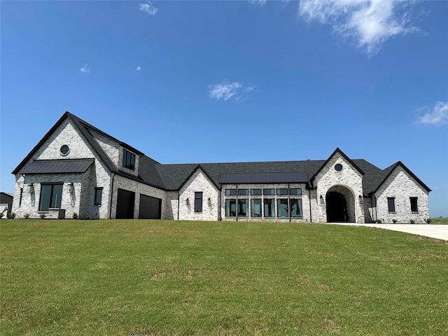 french country style house with a garage and a front yard