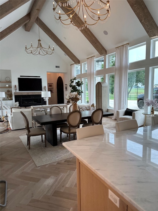 dining area featuring beamed ceiling, light parquet flooring, a chandelier, and high vaulted ceiling