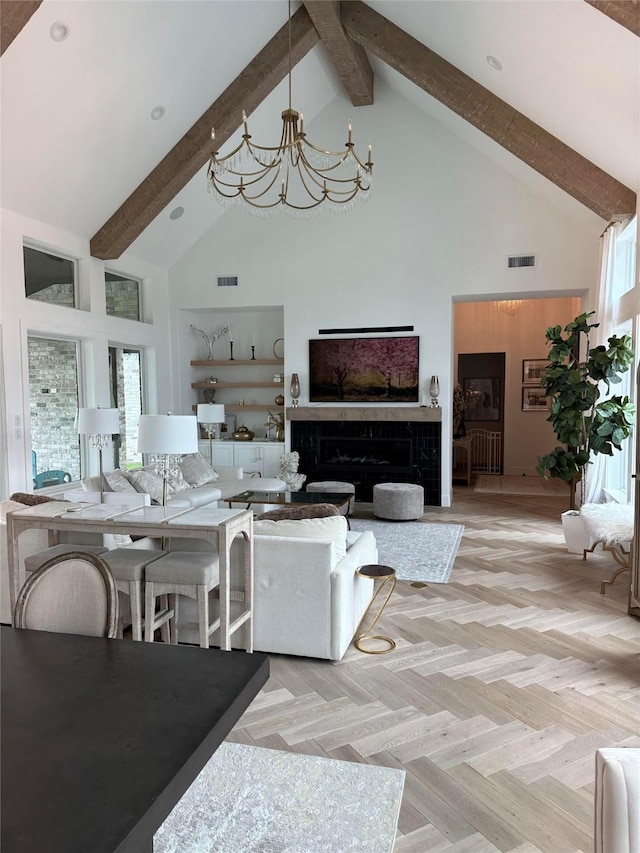 living room featuring beam ceiling, light parquet flooring, high vaulted ceiling, and a chandelier