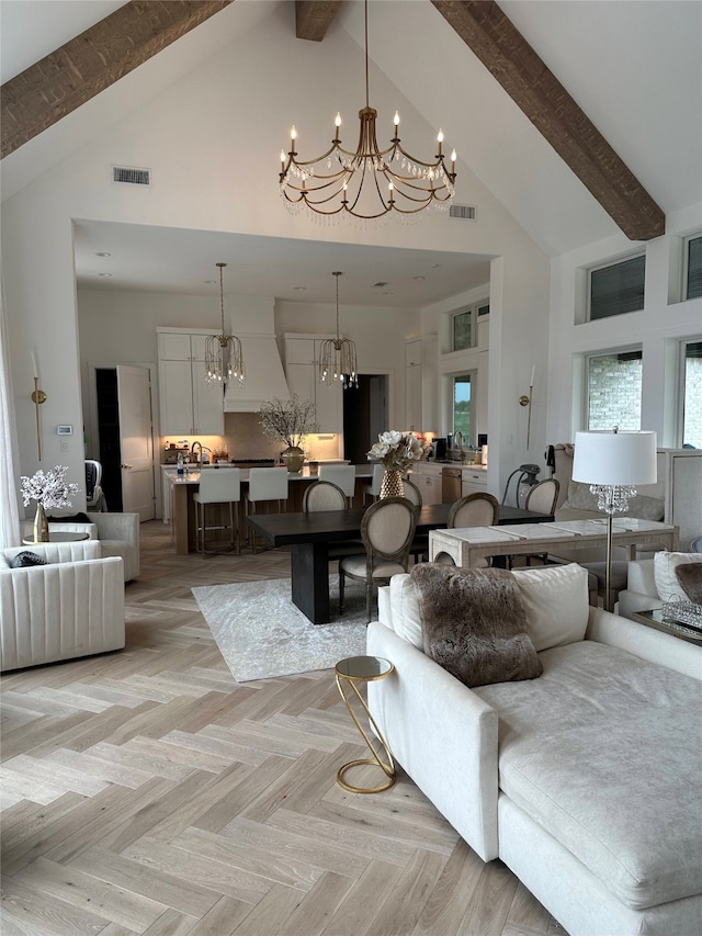 living room featuring light parquet floors, high vaulted ceiling, an inviting chandelier, and beamed ceiling