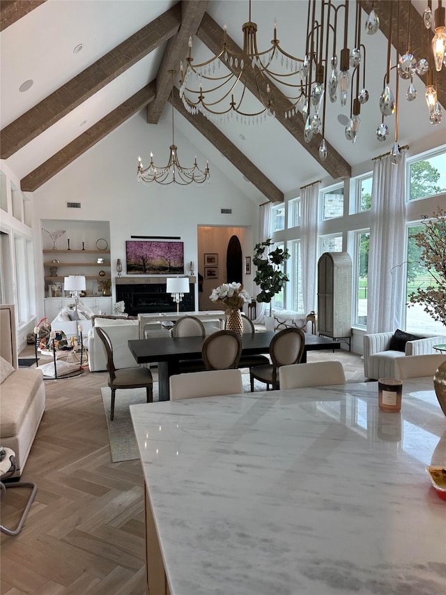 dining room with beamed ceiling, light parquet flooring, built in shelves, and high vaulted ceiling