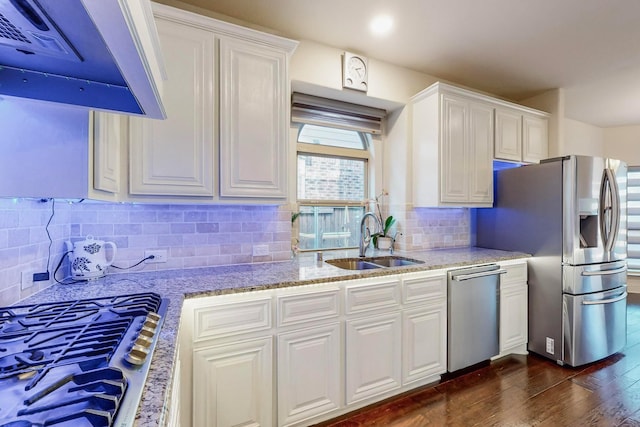 kitchen with white cabinetry, stainless steel appliances, and exhaust hood