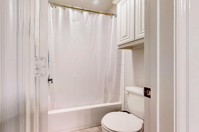 bathroom with toilet and shower / bath combo with shower curtain