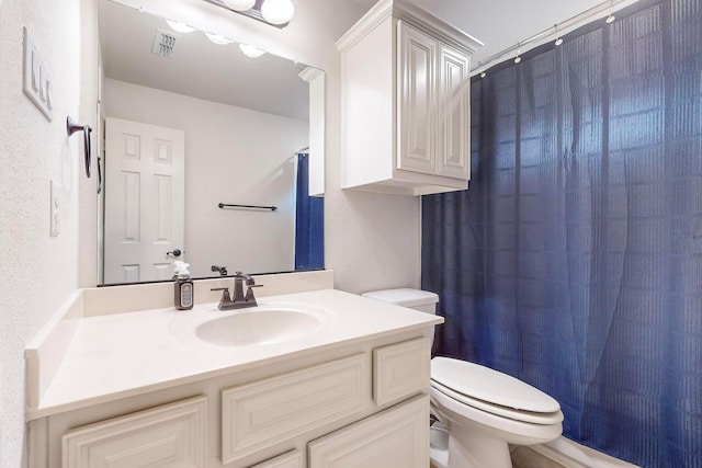 bathroom with vanity, a shower with curtain, and toilet