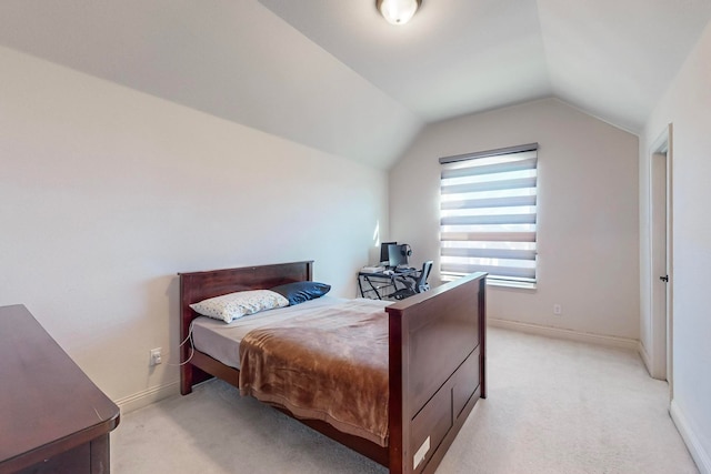 bedroom featuring light carpet and vaulted ceiling