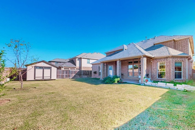 rear view of house featuring a storage shed, a yard, and a patio area