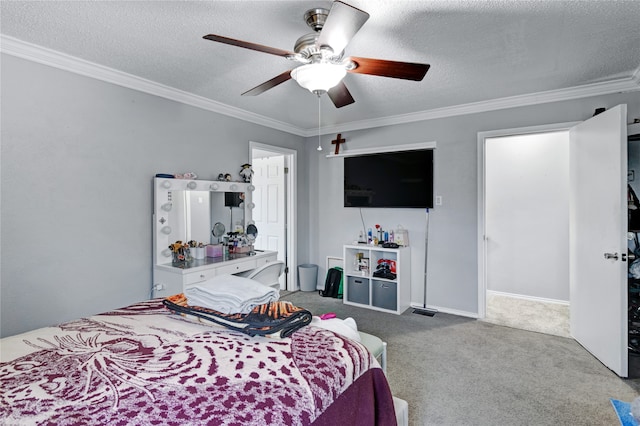 carpeted bedroom featuring ceiling fan, ornamental molding, and a textured ceiling