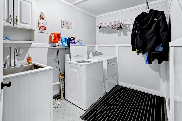 laundry area with cabinets, separate washer and dryer, and sink